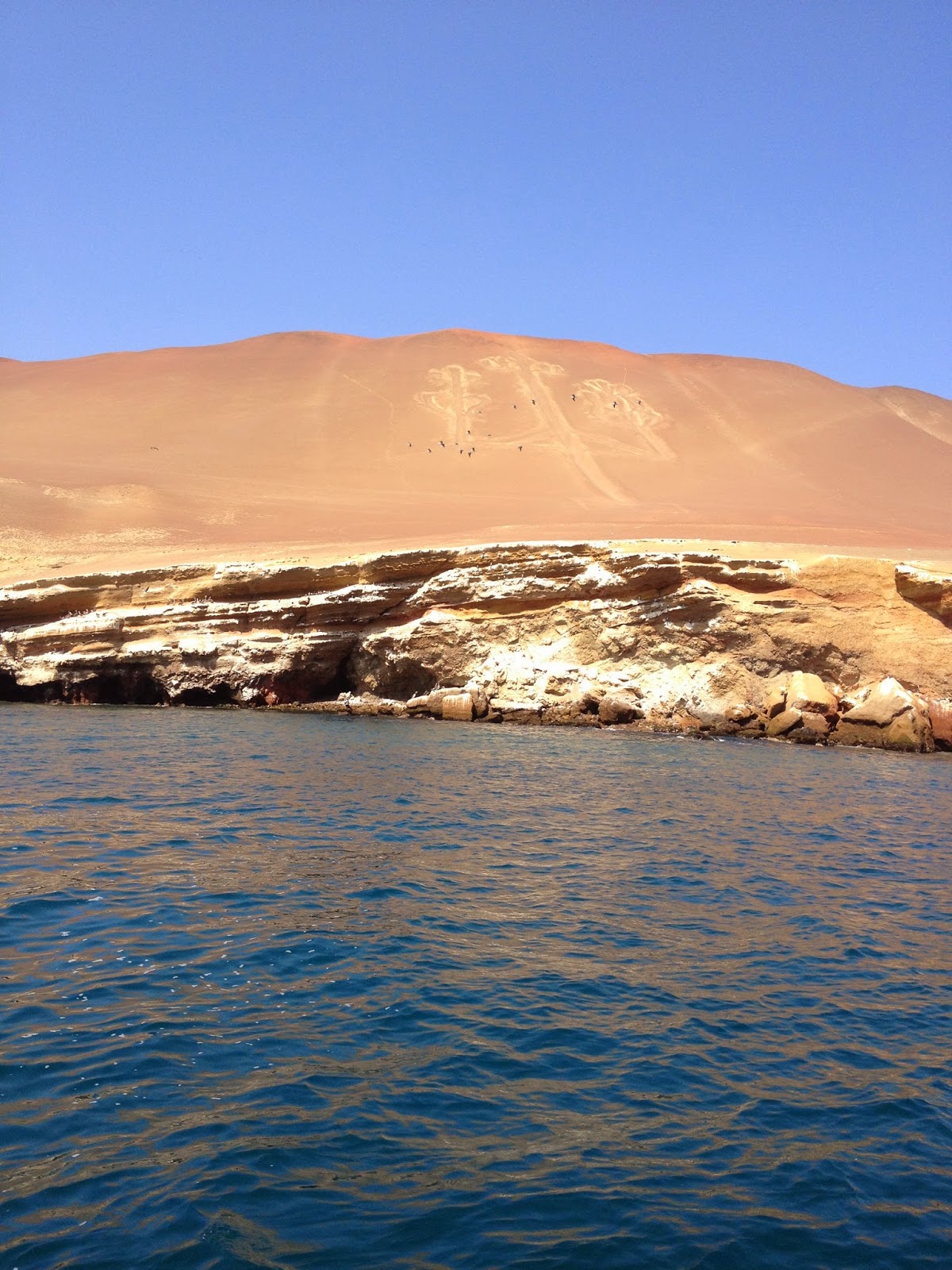 Tourist boat approaching the Ballestas Islands in Paracas National Reserve
