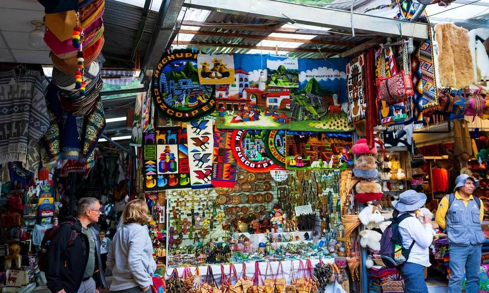 Machu Picchu Artisan Market in Aguas Calientes with colorful Andean textiles and handicrafts